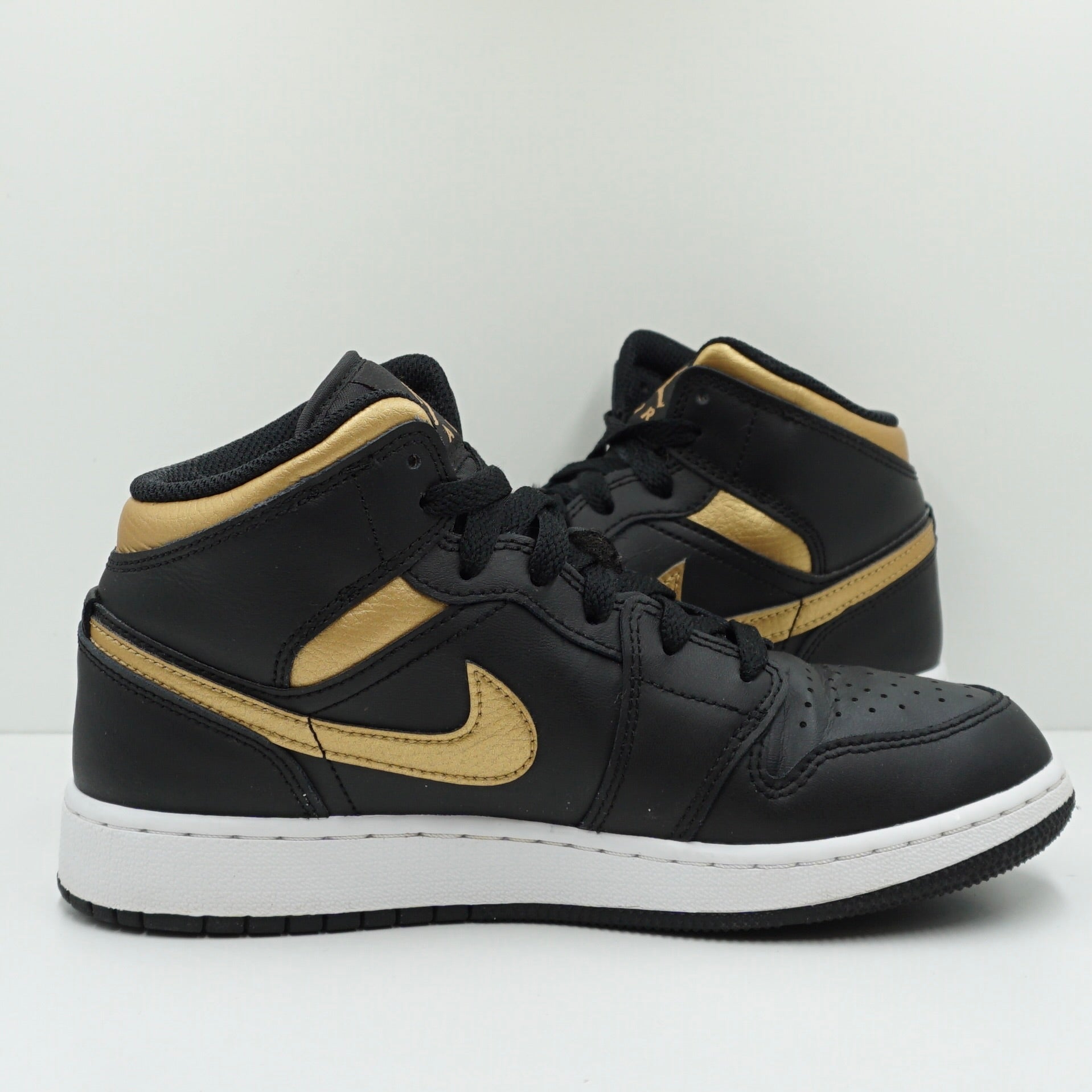 Jordan 1 Mid Black Metallic Gold Swoosh (GS)
