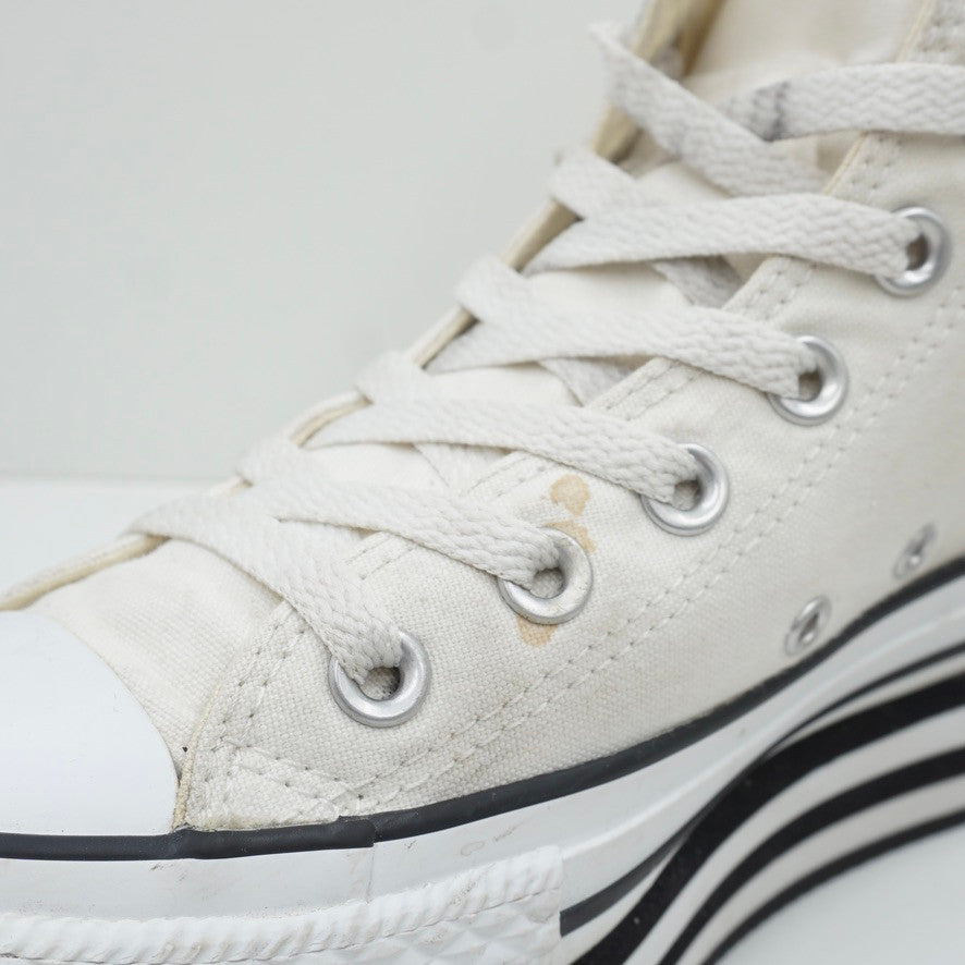 White with store black stripe converse